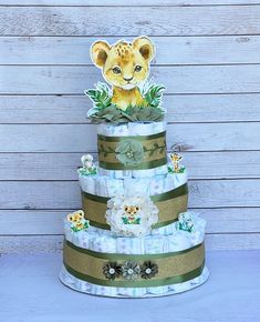 a three tiered diaper cake with a baby lion on it's top