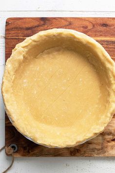 a pie crust sitting on top of a wooden cutting board