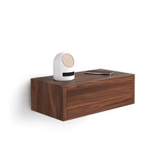 an alarm clock sitting on top of a wooden shelf