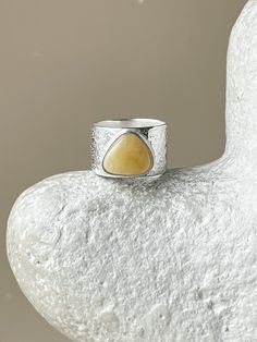 This contemporary statement ring offers amber set in sterling silver. Its bold design makes it ideal for those wanting to make a style statement. Yellow Stone Rings, Astoria Ny, Wide Ring, Amber Ring, Statement Ring Silver, Jewelry Statement, Wide Rings, Yellow Stone, Ring Unique