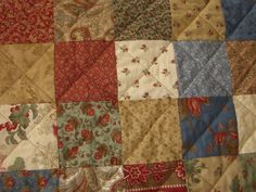 an old quilt with many different colors and patterns