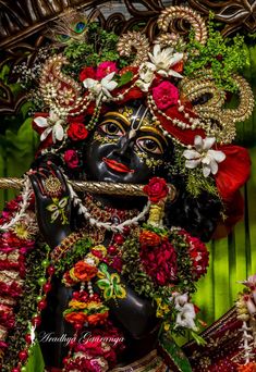 an idol is displayed in the form of a woman with flowers on her head and arms