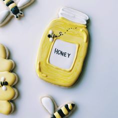 decorated cookies with the words honey on them and bees in front of one cookie that says honey