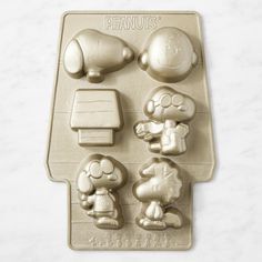 a cookie sheet with peanuts on it and other decorations in the shape of an elephant