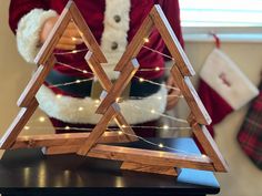 a wooden christmas tree with lights on it