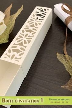 the box is decorated with brown ribbon and paper leaves, along with other decorative items