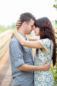 a young man and woman embracing each other