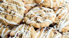 a pile of cookies with white icing on top