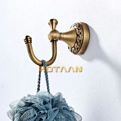 an old fashioned shower faucet is hanging on the wall next to a blue towel