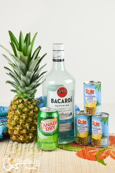 a pineapple and cans of booze sit next to each other