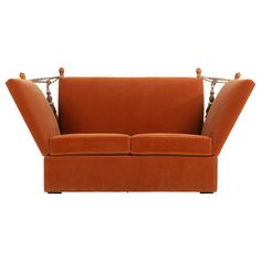 an orange couch with two arms and legs on it's back, sitting against a white background