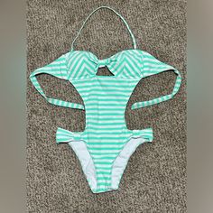 Bikini Lab One Piece Cutout Swimsuit Color: Mint Green/White Stripe Size: M Condition: Nwot, Tried It On With Undies But Never Worn. Ties In Back, Neck Strap Removable, Sparkly And Super Cute!! White Halter Neck One-piece Swimsuit, White Beachy Bodysuit For Pool, Green Cutout Swimwear For The Beach, White Cutout Swimwear For Summer, White Halter Neck One Piece For Pool, White Cutout Swimwear For Poolside, White Cutout Swimwear For Swimming, White Backless Tankini For Poolside, White Cutout Swimwear