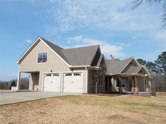 a large house with two garages in the front yard