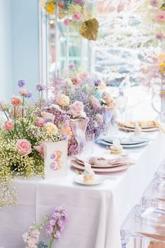 a table with flowers and plates on it