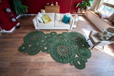 a living room filled with furniture and a rug on top of a hard wood floor