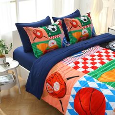 a bed with two pillows on top of it and a basketball themed comforter set