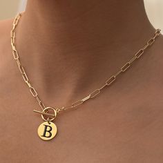 Define your style with our Cleo Paperclip Initial Necklace, a sophisticated accessory that brings together elegance and personalization. This 14k gold necklace allows you to carry your initials or those of a loved one close to your heart. Its versatile design offers you the choice of wearing it alone or pairing it with other pieces for a layered look. It's a perfect gift for yourself or someone special in your life. Initial Disc: Available in 14k Plated or Stainless Steel, engraved with 1 to 3 i Gold Plated Paperclip Chain Necklace, Elegant Tarnish Resistant Initial Pendant Chain Necklace, Elegant Tarnish-resistant Initial Pendant Chain Necklace, Chic Tarnish-resistant Charm Necklace Gift, Elegant Oval Link Charm Necklace For Gifts, Elegant Paperclip Charm Necklaces For Everyday, Elegant Charm Necklace With Paperclip Chain As Gift, Elegant Monogram Charm Necklaces For Everyday, Elegant Monogram Charm Necklace For Everyday