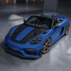 a blue and black sports car parked in a garage