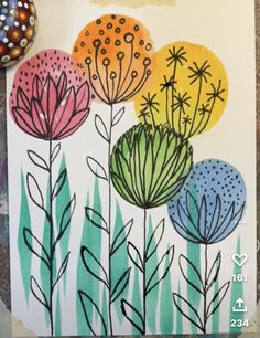 a card with flowers painted on it