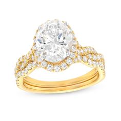 Start the next exciting chapter in your love story with the beautiful twist design of this oval lab-created diamond frame bridal set in 14K gold. Fashioned in 14K gold The engagement ring showcases a 2 ct. certified oval-shaped lab-created diamond boasting a color rank of I and clarity of Si2. Lab-created diamonds sparkle along the halo frame and the twist ribbons of the shank. A contoured wedding band adds a final layer of shimmering lab-created diamonds to the look. Includes certification card Oval Halo Yellow Gold Wedding Ring, Classic Oval Bridal Sets For Formal Occasions, Oval Diamond Cut Wedding Ring, Oval Brilliant Cut Bridal Sets For Anniversary, Oval Diamond Bridal Sets With Center Stone, Elegant Oval Bridal Sets For Anniversary, Formal Oval Bridal Sets With Prong Setting, Oval Diamond Bridal Sets For Anniversary, Elegant Oval Cubic Zirconia Bridal Sets