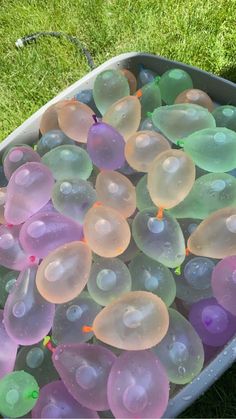 a bucket filled with lots of bubbles in the grass