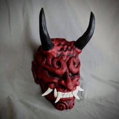 Woodland Oni  style Noh maskBased off traditional Japanese Noh Masks. Made of PLA and hand painted in acrylics. This mask is large enough to be wearable by most people.  Comes as mask only without straps.Inside dimensions are: 240 H x 150 W mm/   9.5 H x   6 W inOverall Dimension: 340 H x 190 W mm/  13.5H x  7.5 W inEach piece is individually made to order so keep in mind: It will possibly take a couple weeks to paint and get it shipped out. The paint and coloring may differ slightly the picture Traditional Cosplay Masks And Prosthetics, Traditional Cosplay Masks, Traditional Halloween Masks And Prosthetics, Handmade Traditional Mask, Red Oni Mask, Japanese Oni Mask, Japanese Noh Mask, Japanese Yokai, Cardboard Mask