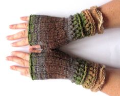 a woman's hand is wearing a pair of knitted fingerless gloves