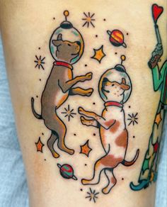 a tattoo on the leg of a person with a dog and astronaut's helmet