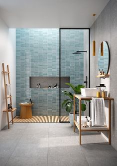 a bathroom with blue tiles on the walls and floor