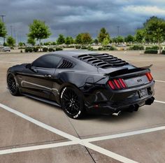 a black sports car parked in a parking lot