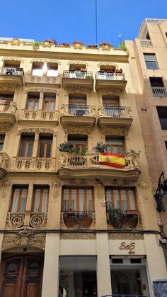 a tall building with lots of windows and balconies