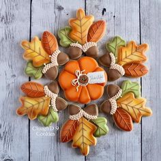 cookies decorated with leaves and acorns are arranged in the shape of a flower