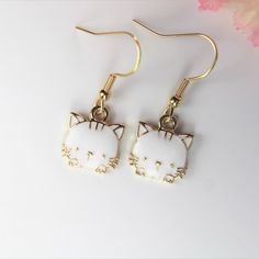 ♥ Best Christmas White Cat Earrings Cute Cat Charm Pet Gift Animal Charm Love Cat Gift Cute Kitty Gift Birthday Gift Personalized Gift ♥ This is Beautiful Gold White Cat Earrings Charm on ear hook ♥ You will receive 1 pair ♥ Alloy Charm Cat Plated Light Gold White Enamel Lead & Nickel Free about : 15x13x3 mm **Conversion : inch 25.4mm or 1mm =0.0393 inches ♥ ear hook 19 mm ♥ We strive for next day shipping, but we do not ship on Saturdays, Sundays, and Holidays. It may sometimes take a bit l Novelty Cat Ears Jewelry Gift, Kawaii Cat Ears Jewelry For Gift, Cute Cat Design Earrings For Gift, Cute Cat Design Earrings As Gift, Kawaii Cat Design Jewelry Gift, White Cat Design Jewelry With Cat Ears, Novelty White Cat Design Jewelry, Cute White Jewelry With Cat Design, Cute White Cat Ears Jewelry