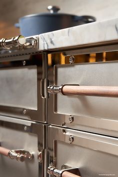 an oven with two doors and copper handles