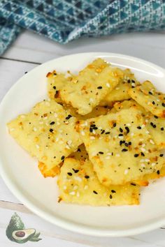 some food on a white plate with sesame seeds