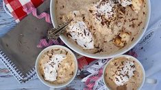 two mugs filled with dessert sitting on top of a table