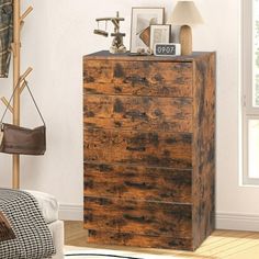 a wooden chest of drawers in a living room