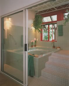 a bathroom with a jacuzzi tub next to a window and tiled flooring