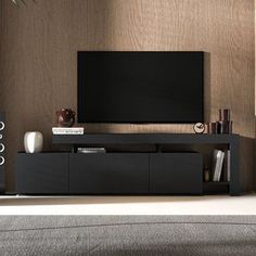 a flat screen tv sitting on top of a black entertainment center in a living room