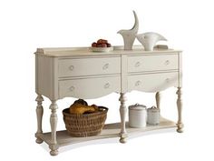 a white dresser with drawers and baskets on it