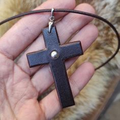 Leather Cross with a silver ballNecklace accessory made of genuine leather.Please choose from the three available colors - brown, black, tobacco.he lace is made of genuine leather and has a silver fasteningDimension:thickness 0,1''height 2,3''width 1,1'' Adjustable Brown Cross Pendant Necklace, Brown Crucifix Cross Necklace As Gift, Handmade Brown Cross Jewelry, Adjustable Brown Cross Necklace, Handmade Brown Cross Pendant Necklace, Handmade Brown Cross Necklace, Diy Leather Wallet, Silver Ball Necklace, Cross Shape