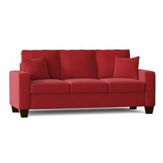 a red couch sitting on top of a white floor