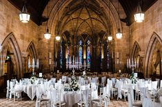 the inside of an old church with tables and chairs set up for a formal function