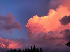 the clouds are pink and purple as the sun sets