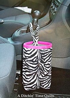 a zebra print bag sitting in the front seat of a car