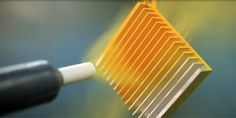 a close up of a yellow comb on a table