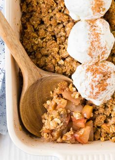 a casserole dish with apples and whipped cream