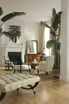 a living room filled with furniture and a fire place in the middle of a room