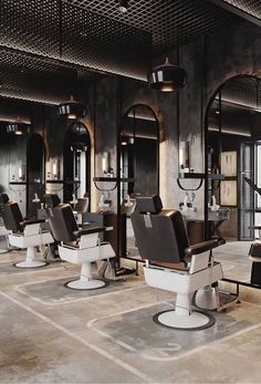 the interior of a barbershop with many chairs and mirrors on the walls,