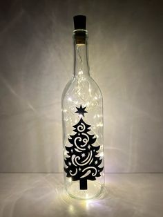 a bottle with a christmas tree in it